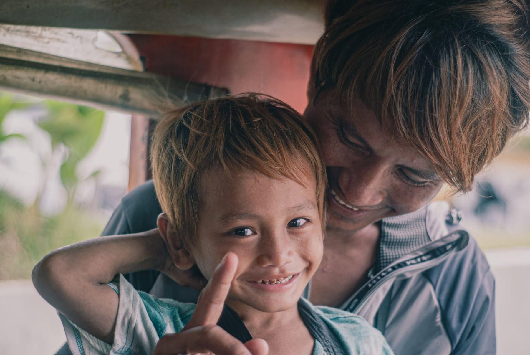 Candid portrait of a smiling young boy and a man sharing a joyful moment together